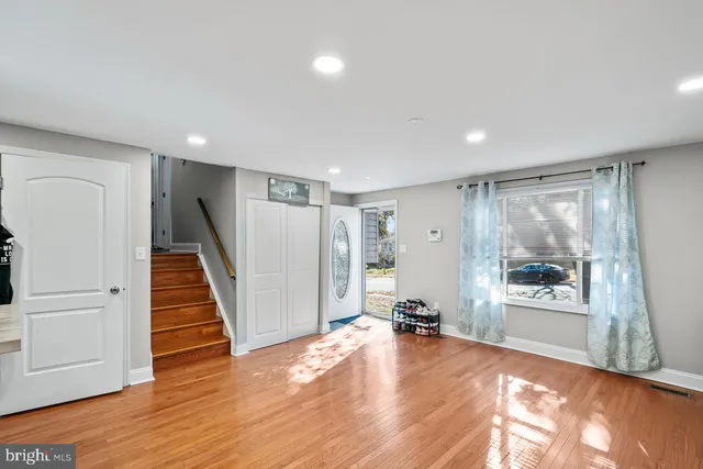 a view of a room with wooden floor and windows