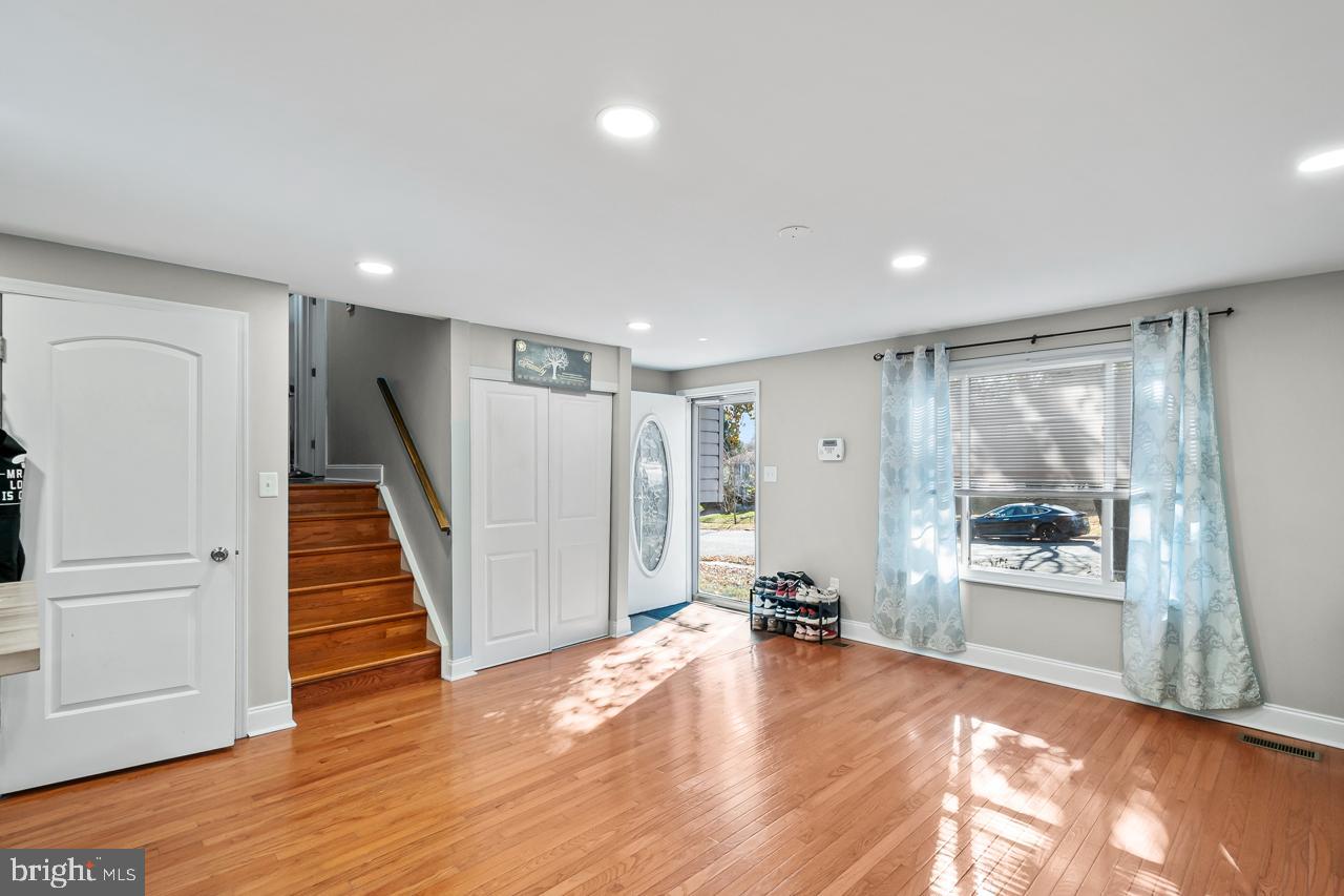 7002 Killarney Street Clinton, MD 20735 - Photo 7 of 26 a view of a room with wooden floor and windows