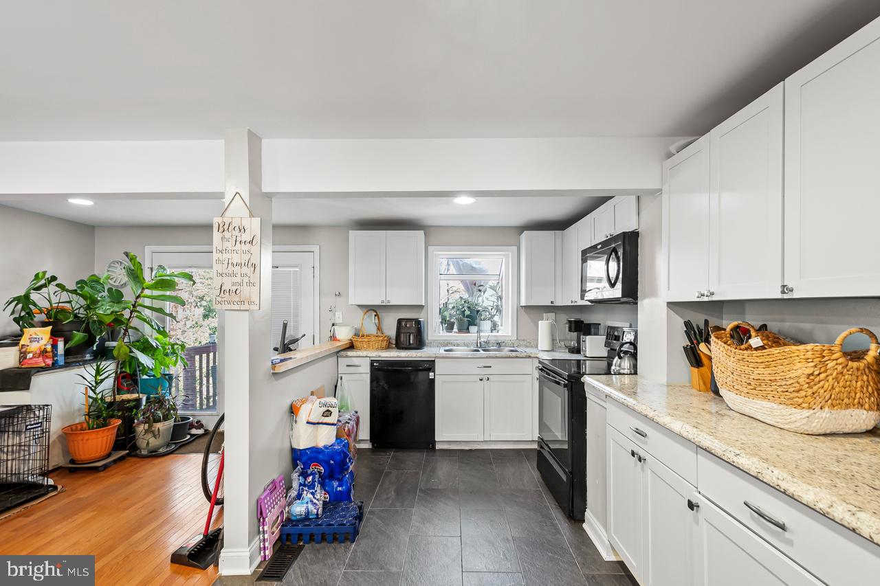 7002 Killarney Street Clinton, MD 20735 - Photo 10 of 26 a kitchen with a sink stove and cabinets