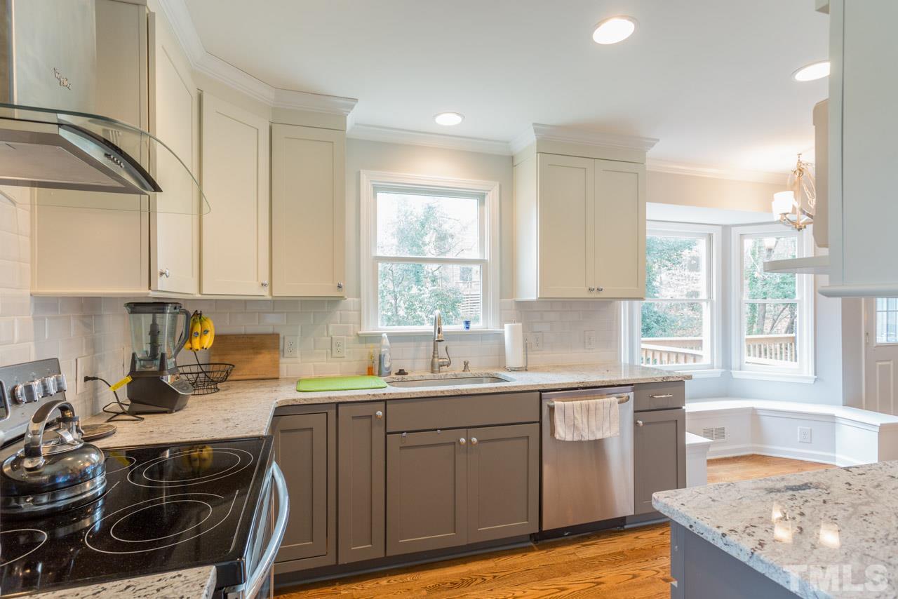 6108 Ivy Ridge Road Raleigh, NC 27612 - Photo 12 of 23 a kitchen with a sink stove and cabinets