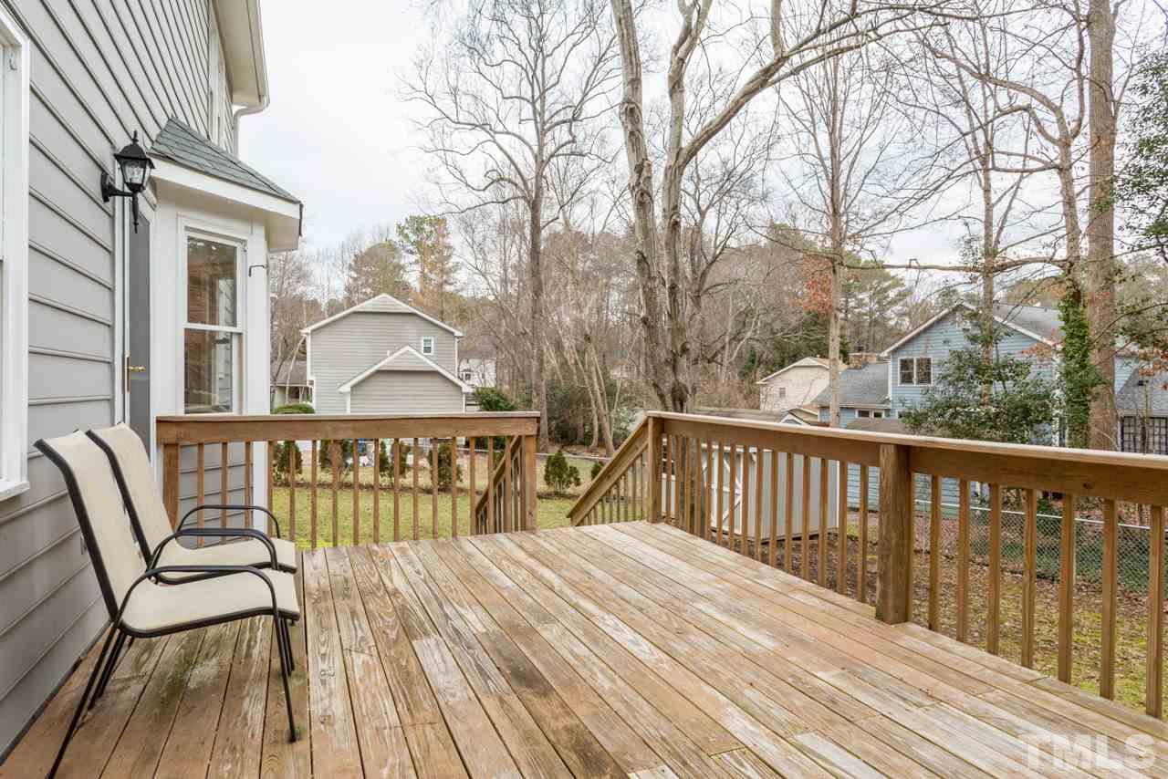 6108 Ivy Ridge Road Raleigh, NC 27612 - Photo 3 of 23 a view of a wooden chairs on deck with wooden floor and fence