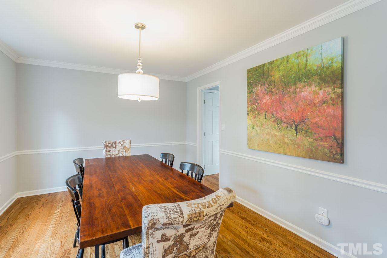 6108 Ivy Ridge Road Raleigh, NC 27612 - Photo 4 of 23 a bedroom with a bed and a painting on the wall