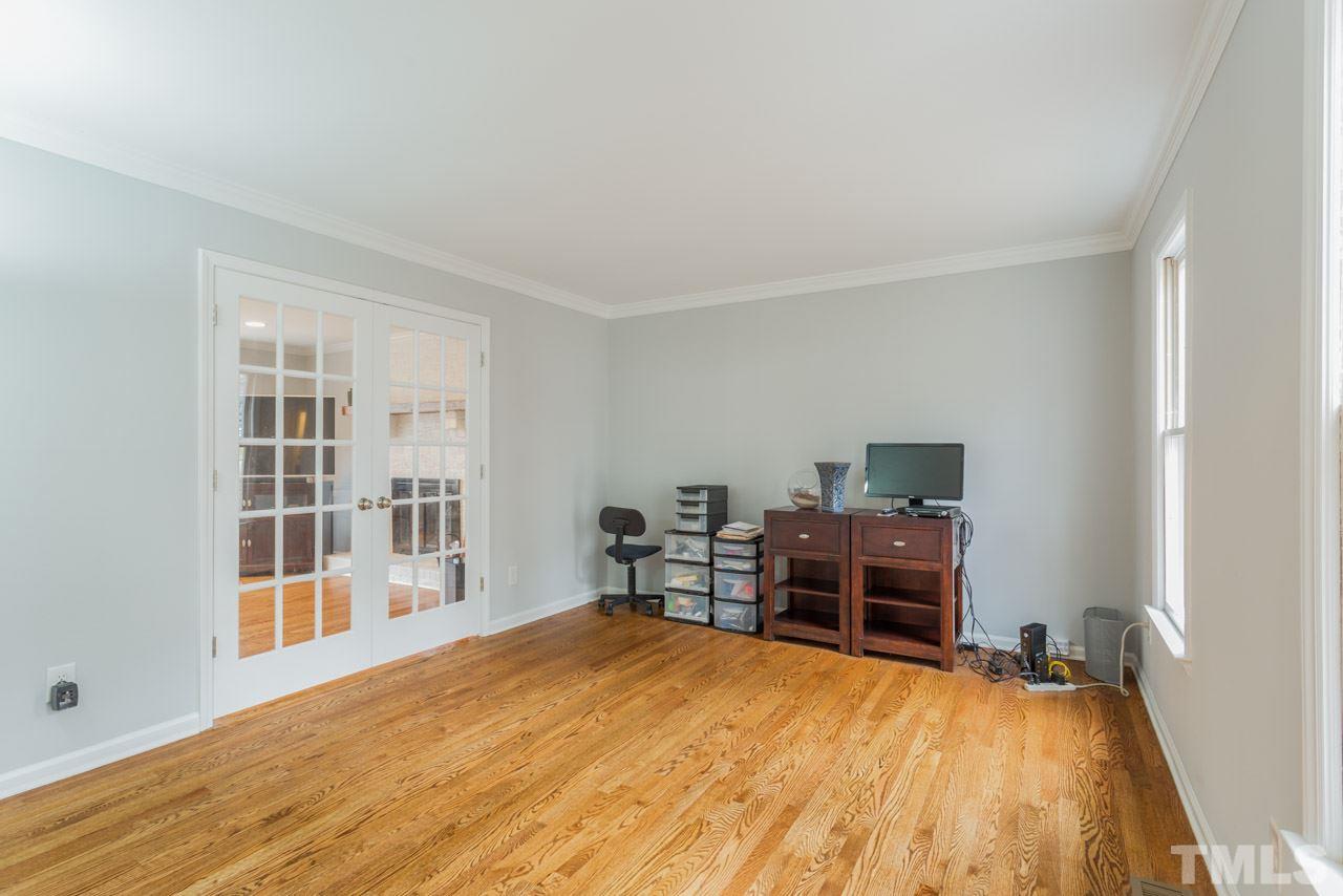6108 Ivy Ridge Road Raleigh, NC 27612 - Photo 6 of 23 a bedroom with a bed and wooden floor