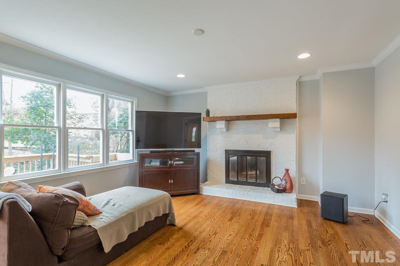 6108 Ivy Ridge Road Raleigh, NC 27612 - Photo 7 of 23 a living room with a couch and a fireplace
