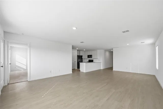 a view of a kitchen with a sink and a refrigerator