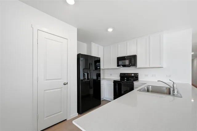 a kitchen with stainless steel appliances a refrigerator stove microwave and sink