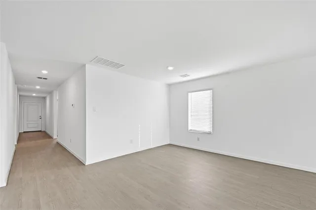 an empty room with a window and pillar in it