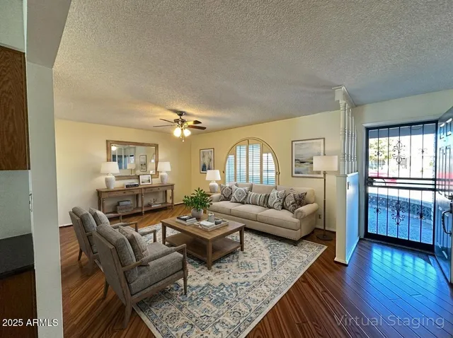 a living room with furniture and wooden floor