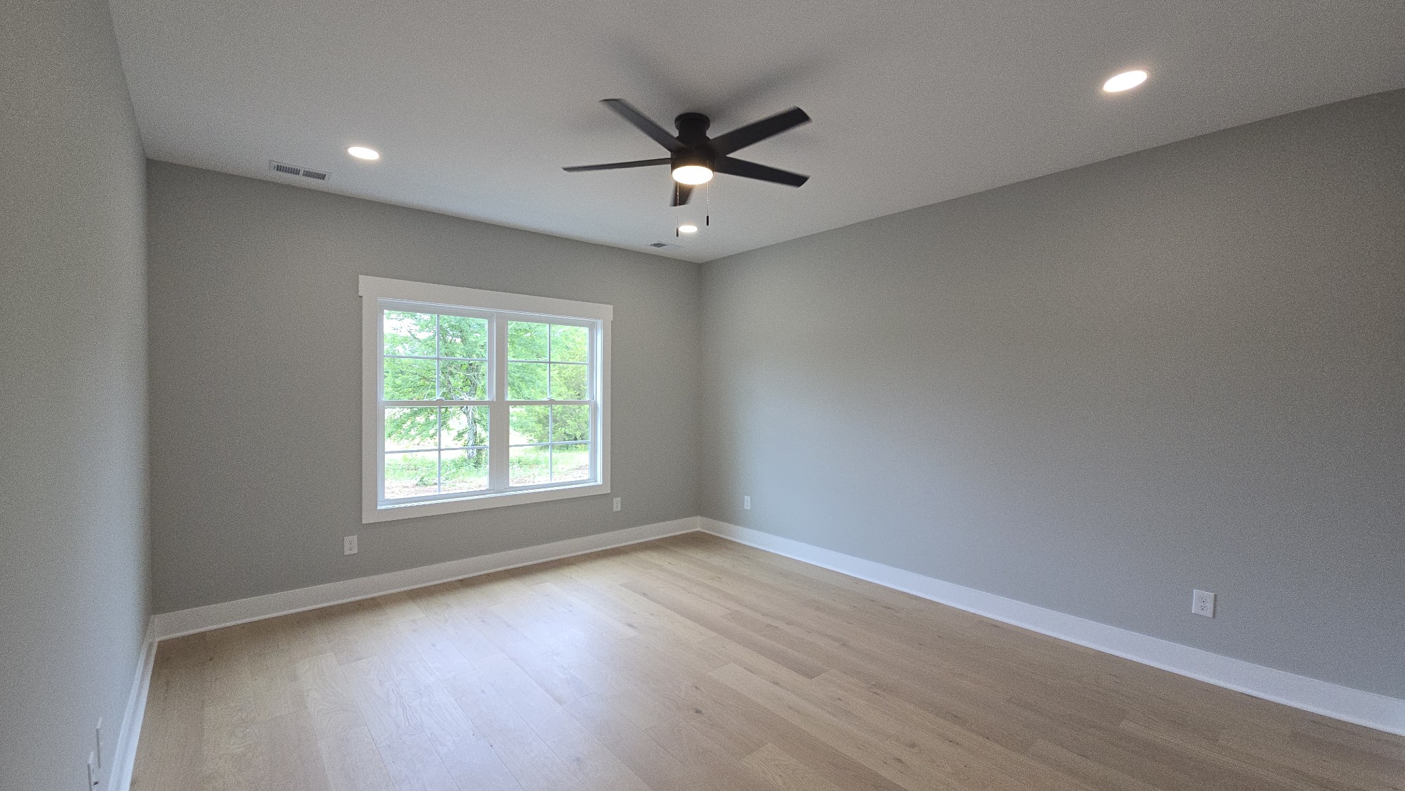 11533 Karo Road Bell Buckle, TN 37020 - Photo 7 of 22 an empty room with wooden floor fan and windows