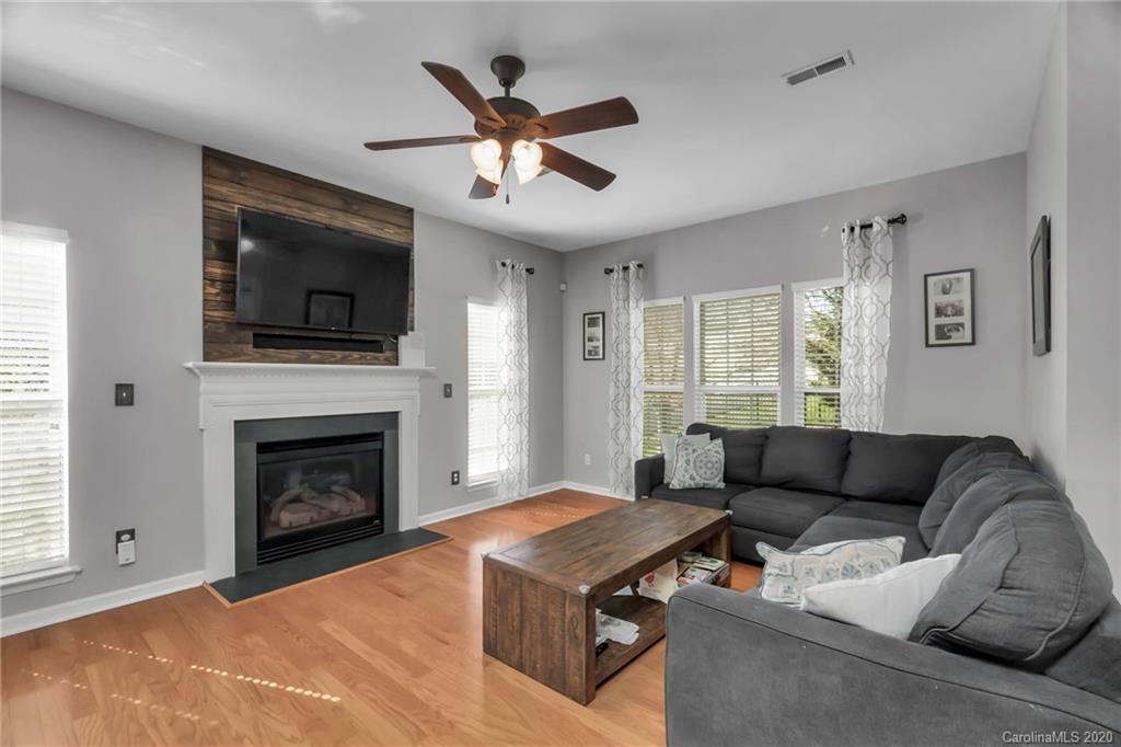 5548 Alexandrite Way, Unit 422 Fort Mill, SC 29708 - Photo 12 of 35 a living room with furniture a flat screen tv and a fireplace