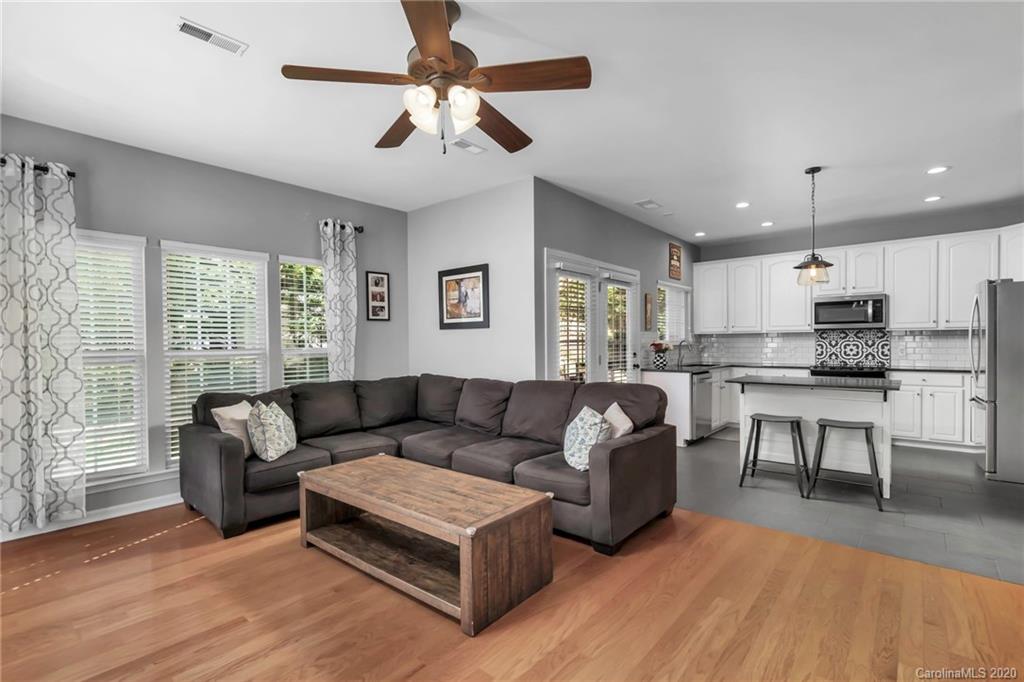 5548 Alexandrite Way, Unit 422 Fort Mill, SC 29708 - Photo 13 of 35 a living room with furniture and a wooden floor