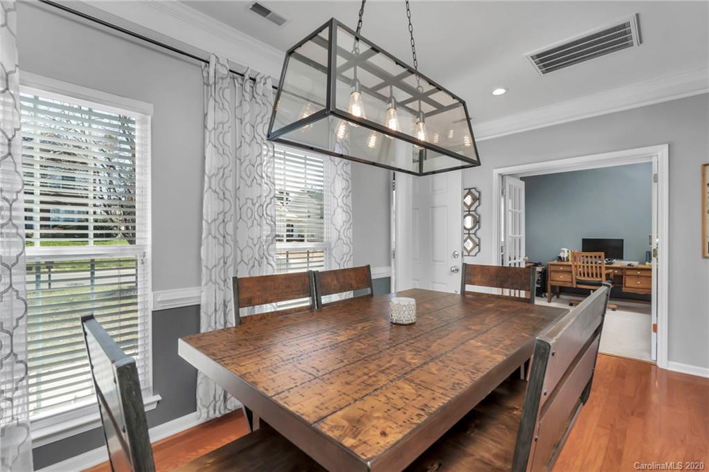 5548 Alexandrite Way, Unit 422 Fort Mill, SC 29708 - Photo 15 of 35 a view of a dining room with furniture and wooden floor