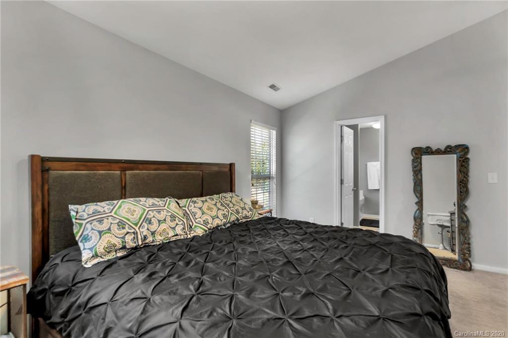 5548 Alexandrite Way, Unit 422 Fort Mill, SC 29708 - Photo 19 of 35 a bedroom with a bed and a mirror