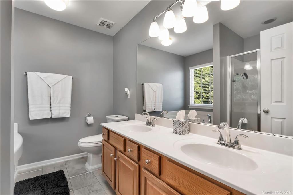 5548 Alexandrite Way, Unit 422 Fort Mill, SC 29708 - Photo 20 of 35 a bathroom with a double vanity sink and a mirror
