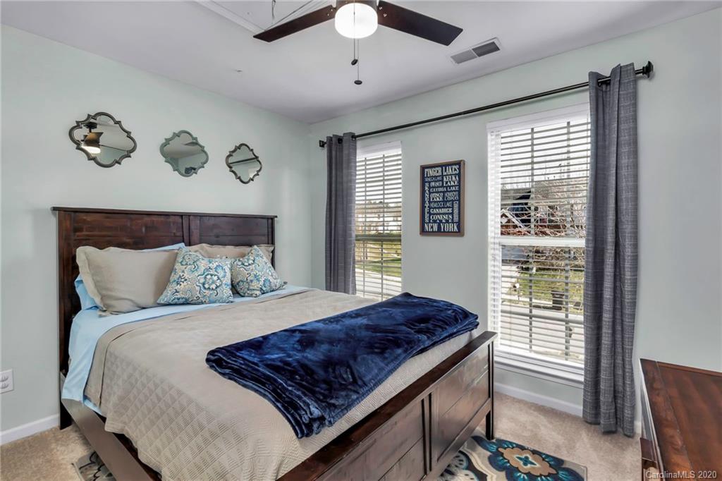 5548 Alexandrite Way, Unit 422 Fort Mill, SC 29708 - Photo 22 of 35 a bedroom with a large bed and a window