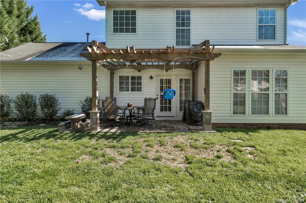 5548 Alexandrite Way, Unit 422 Fort Mill, SC 29708 - Photo 29 of 35 a view of a house with backyard sitting area and garden