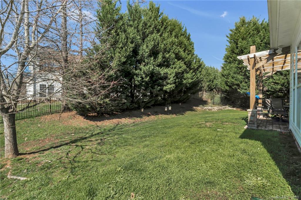 5548 Alexandrite Way, Unit 422 Fort Mill, SC 29708 - Photo 31 of 35 a view of a yard with plants and large trees