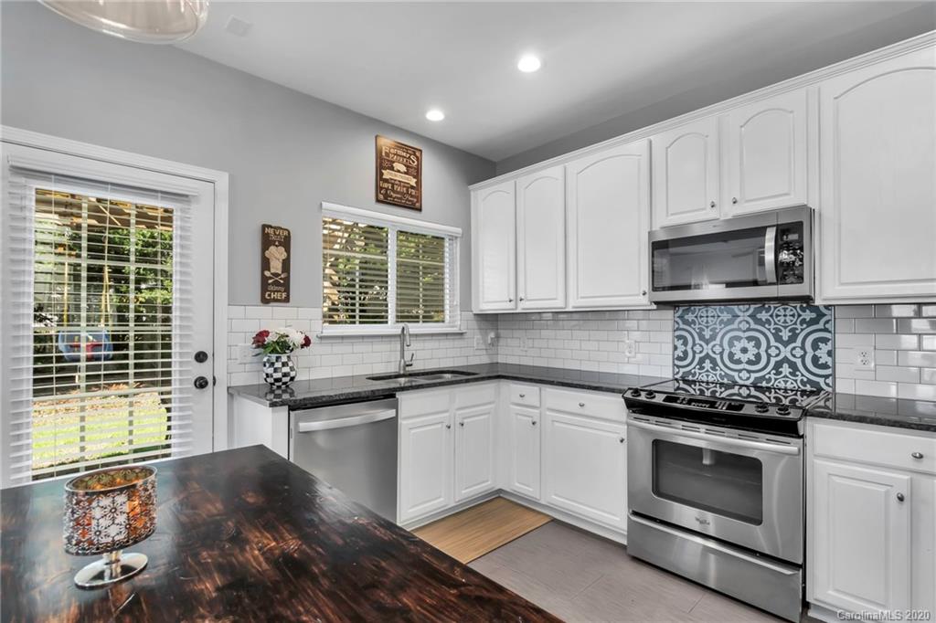 5548 Alexandrite Way, Unit 422 Fort Mill, SC 29708 - Photo 7 of 35 a kitchen with granite countertop a stove and a sink