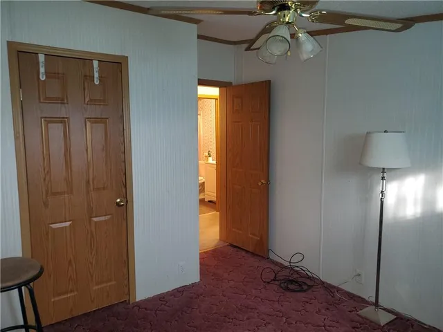 a view of an entryway door with hallway view