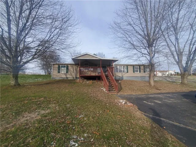 a view of a house with a yard and garage