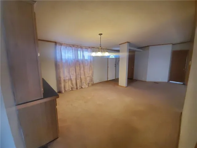 a view of a livingroom with an empty space and a ceiling fan