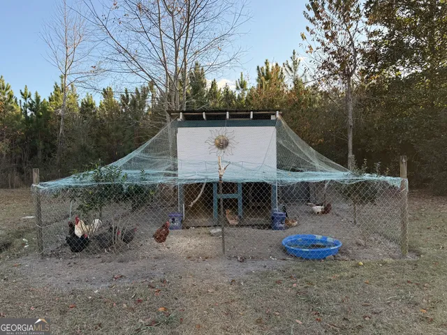 a view of backyard and wooden play house