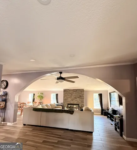 a living room with furniture and a wooden floor