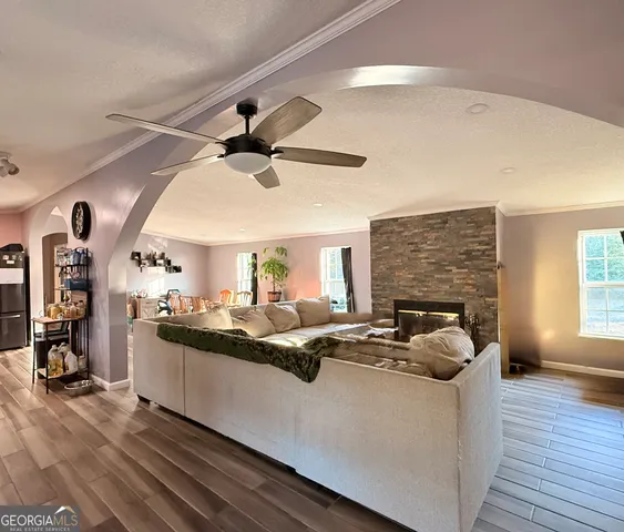 a living room with fireplace furniture and a wooden floor