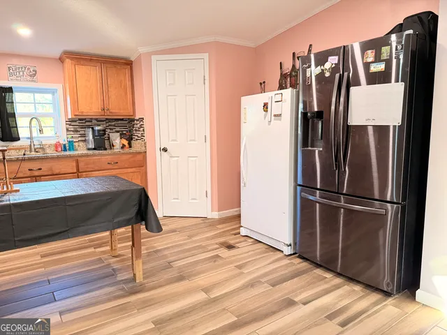 a kitchen with stainless steel appliances granite countertop a refrigerator and a stove top oven