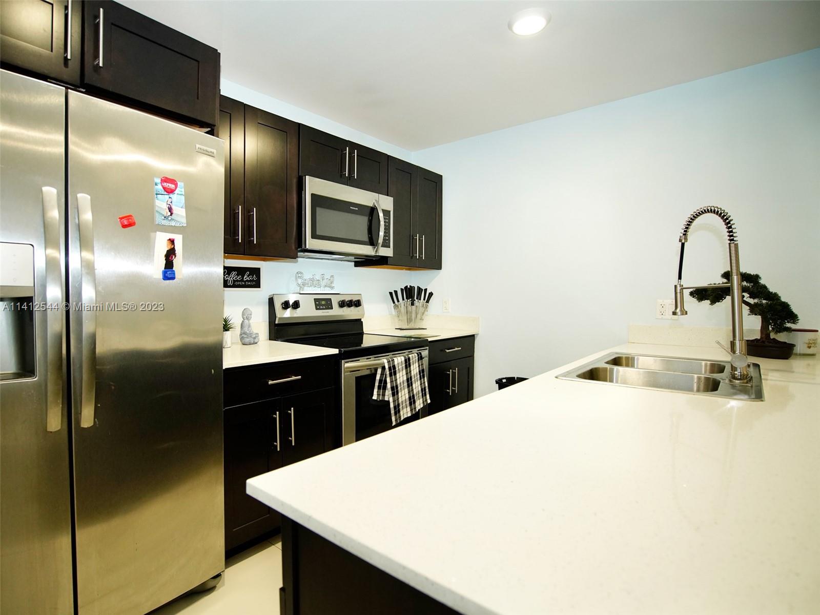 Naranja Homestead, FL 33033 - Photo 2 of 22 a kitchen with a sink a counter top space cabinets and stainless steel appliances