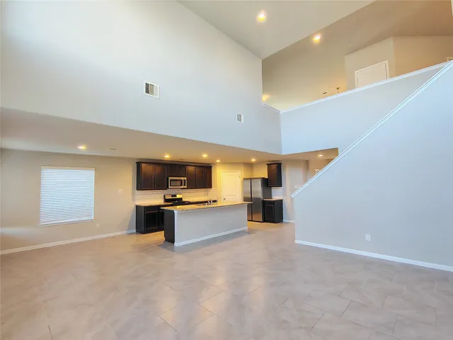a view of kitchen with kitchen island a sink a stove and a refrigerator