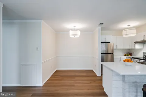 a hallway with wooden floor and windows