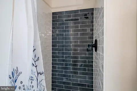 a view of a bathroom with a shower and a sink
