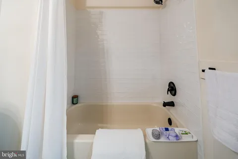 a bathroom with a bathtub and shower