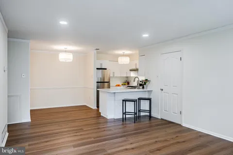 a kitchen with a wooden floor and a window