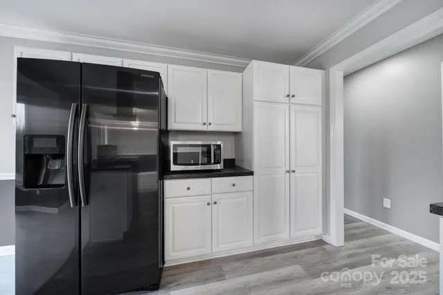 a kitchen with stainless steel appliances a refrigerator and cabinets
