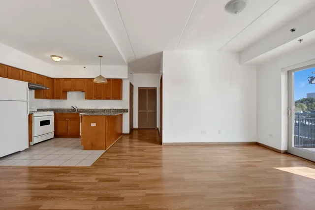 a kitchen with stainless steel appliances a refrigerator and a stove top oven