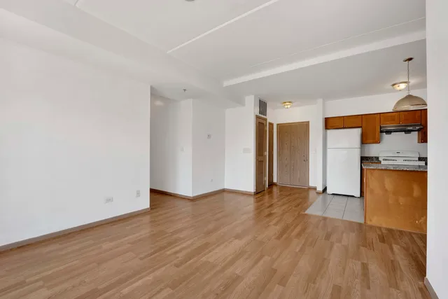 an empty room with wooden floor and a window