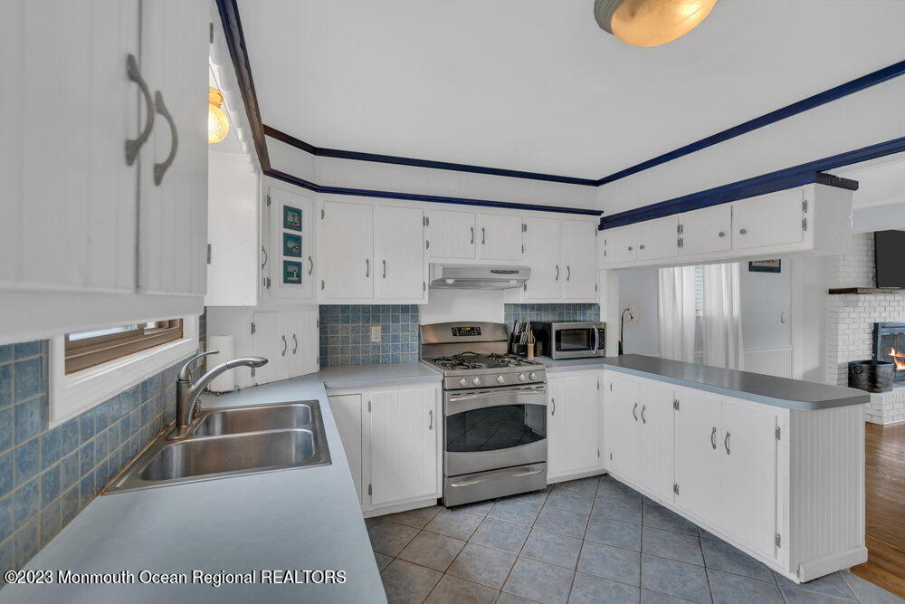 1421 Thomas Street Point Pleasant, NJ 08742 - Photo 11 of 20 a kitchen that has a sink cabinets stainless steel appliances and counter space