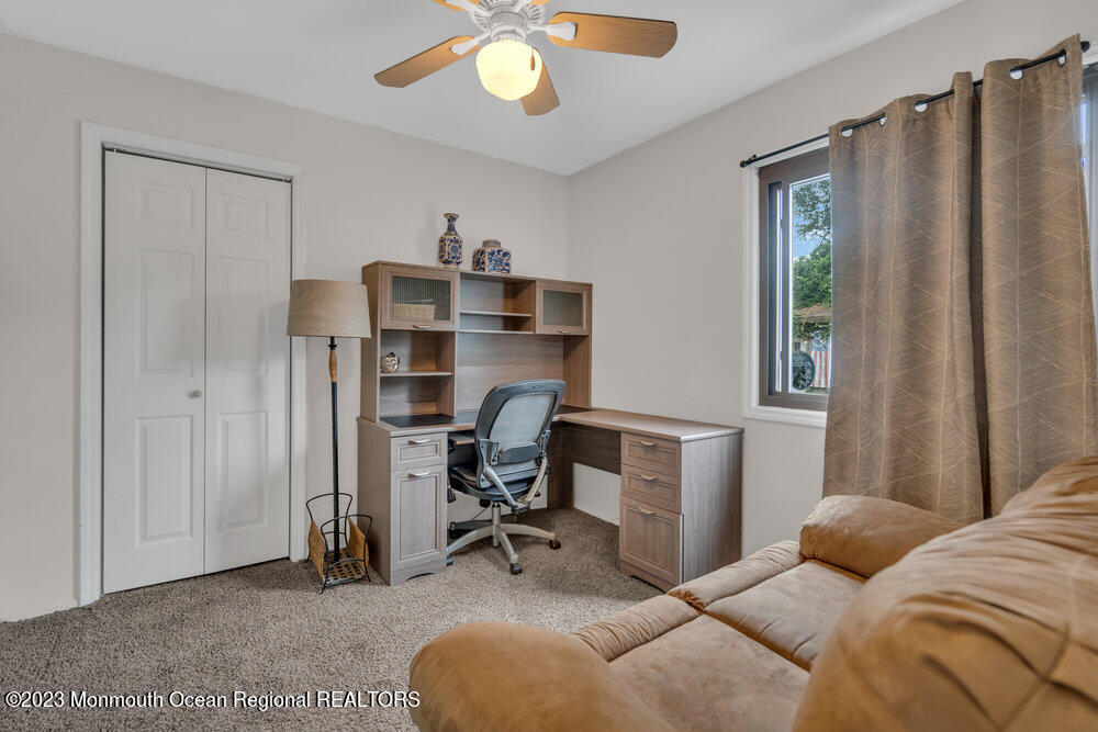 1421 Thomas Street Point Pleasant, NJ 08742 - Photo 16 of 20 a bedroom with a bed and a chandelier