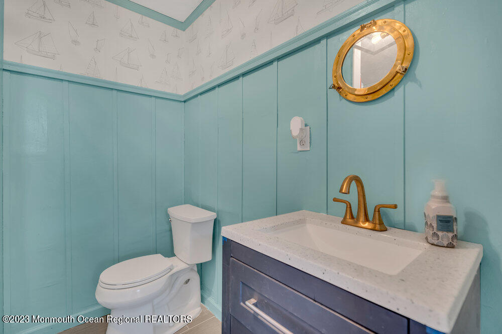 1421 Thomas Street Point Pleasant, NJ 08742 - Photo 18 of 20 a bathroom with a toilet sink and mirror