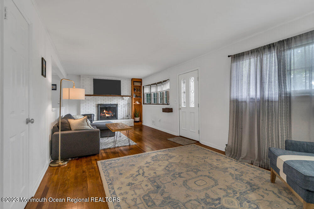 1421 Thomas Street Point Pleasant, NJ 08742 - Photo 8 of 20 a living room with furniture and a fireplace