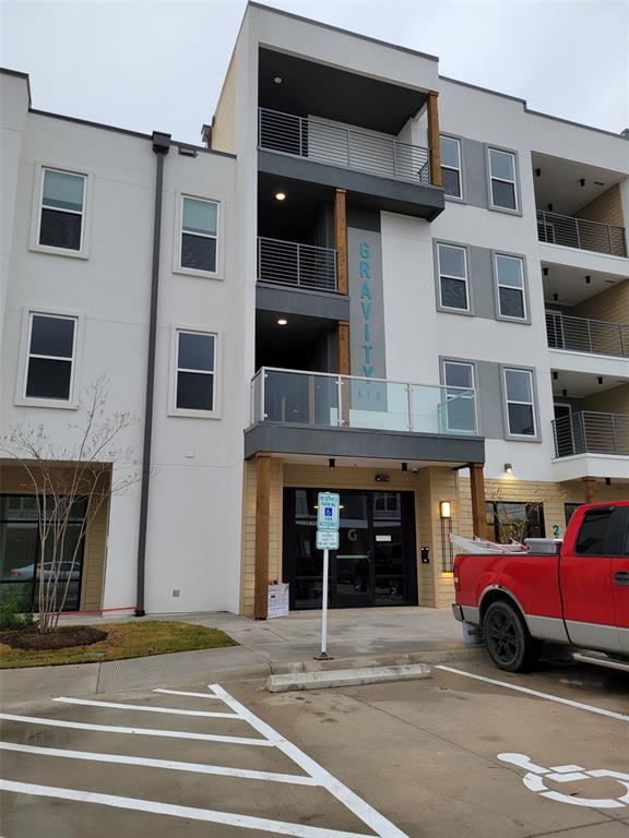 4801 Springdale Road, Unit 2211 Austin, TX 78723 - Photo 17 of 19 A contemporary multi-story building features private balconies and a prominent entrance.