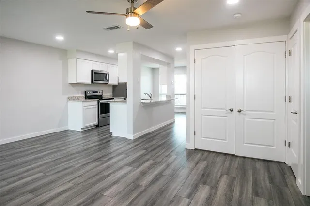 a view of kitchen with wooden floor electronic appliances and window
