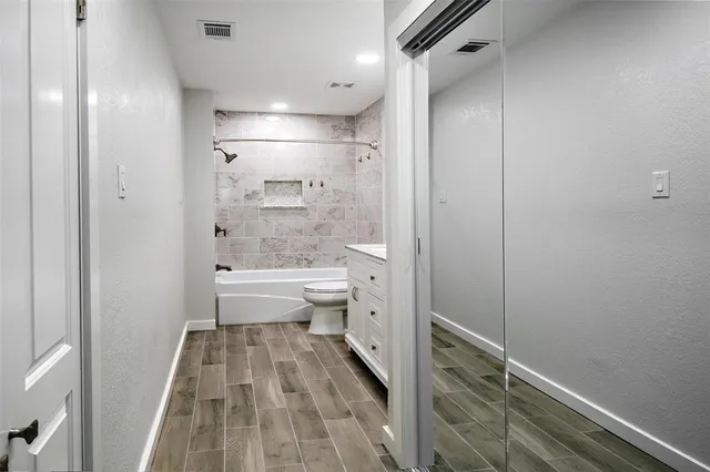 a bathroom with a bathtub and toilet