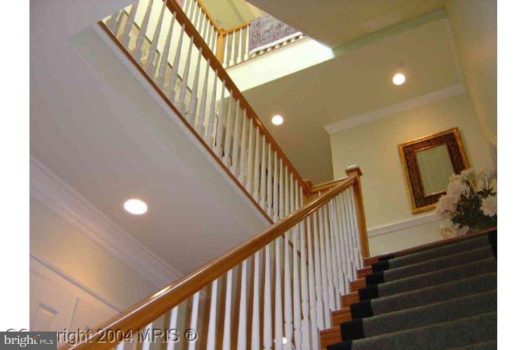 16 7th Street Northeast Washington, DC 20002 - Photo 13 of 15 a view of staircase with lots of frames on wall and a window