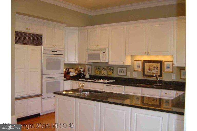 16 7th Street Northeast Washington, DC 20002 - Photo 6 of 15 a kitchen with stainless steel appliances granite countertop a sink a stove and a refrigerator