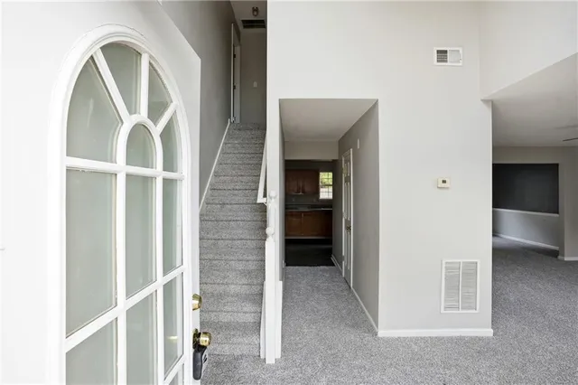 a view of an empty room with a fireplace