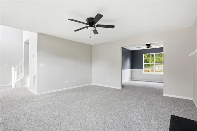 a view of an empty room with a fireplace