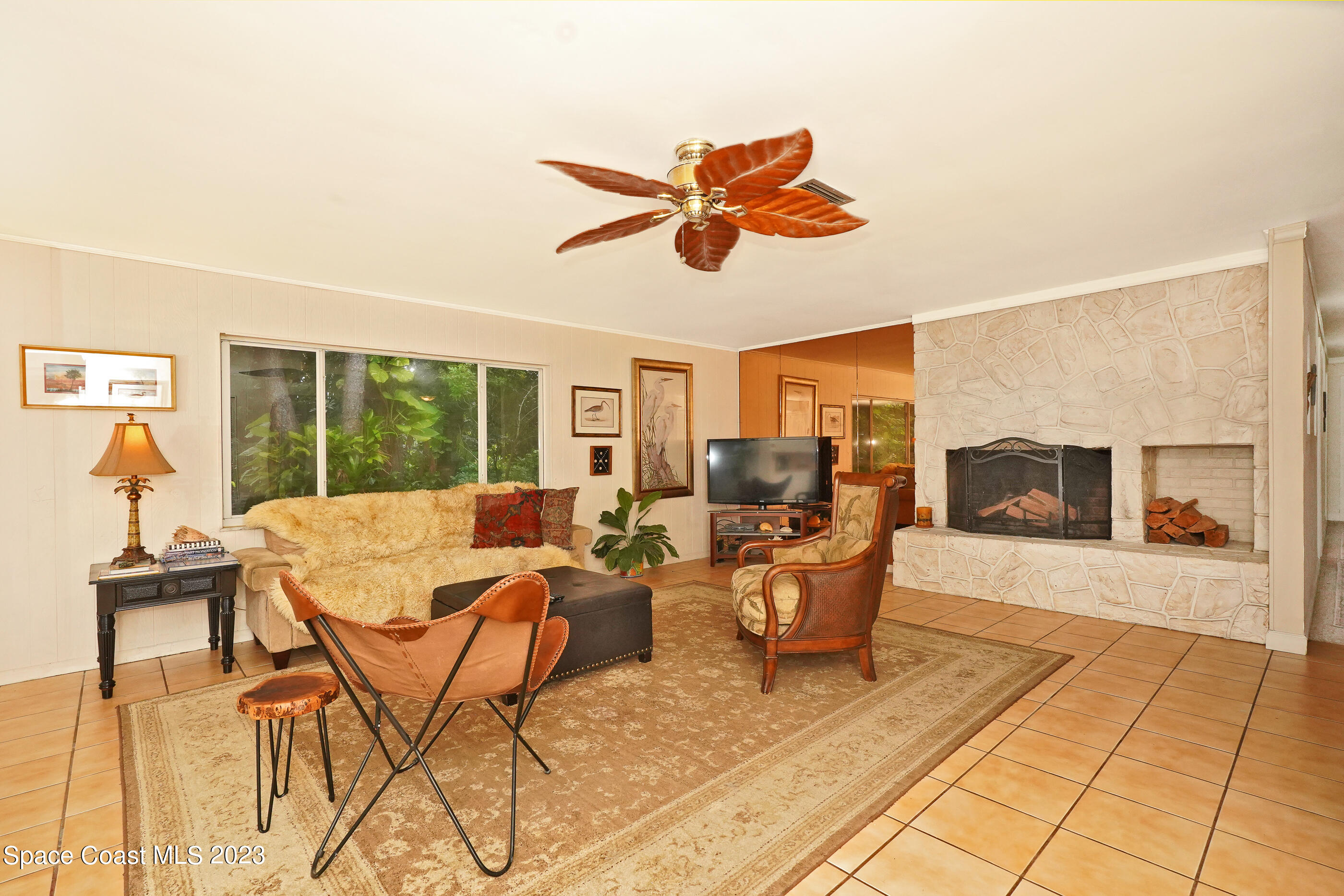 2525 Friday Road Cocoa, FL 32926 - Photo 11 of 77 a living room with patio furniture and a floor to ceiling window